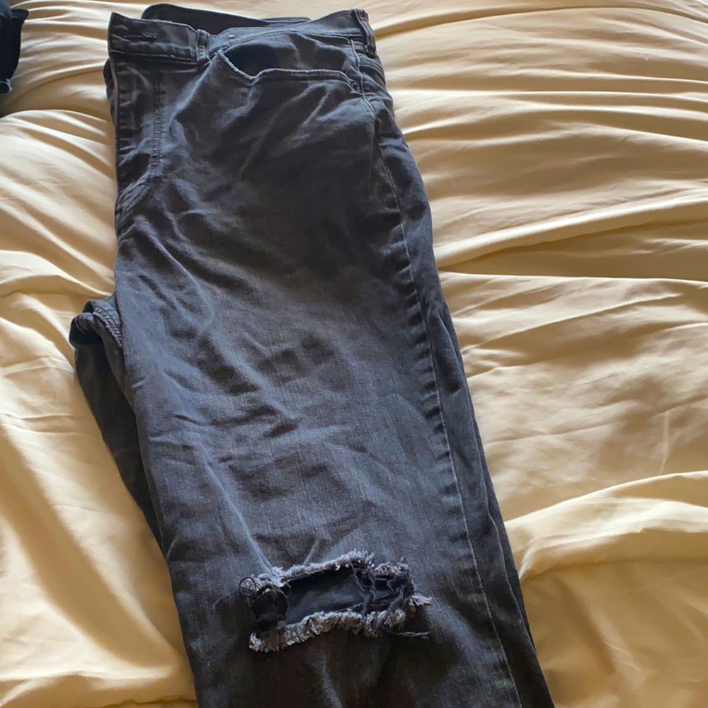 Cute dark gray jeans ripped at knee and ankle. High rise